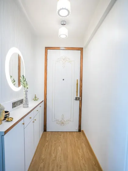 The full view of the tranquil foyer, with its white and wood theme, creates a calming and organized first impression.