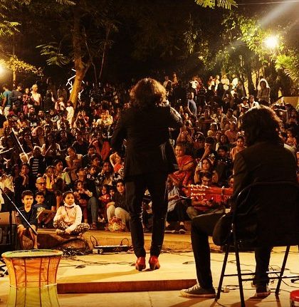 Performing for a massive, enthusiastic crowd at an outdoor festival in Mumbai.