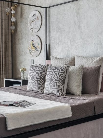 A different angle of the master bedroom with the modern four-poster bed. The textured wallpaper and minimalist decor create a space that feels both luxurious and calming.