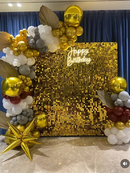 A wider shot of the gold sequin backdrop, showing the full scale of the balloon decoration. The arrangement elegantly frames the shimmer wall, making it an impressive centerpiece for a milestone birthday or a glamorous bachelorette party.