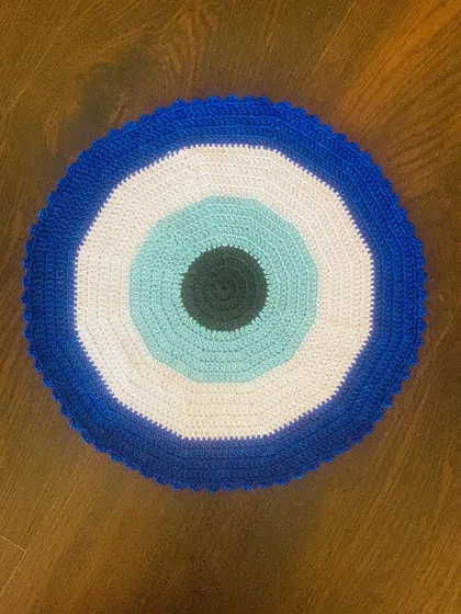 Here is my take on the trendy Evil Eye design, crocheted into a bold placemat. It's a modern and protective symbol that adds a unique and stylish touch to your living space.