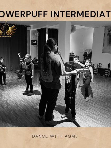 An instructor gives a gentle correction to a student. This personalized guidance is at the heart of our teaching philosophy.