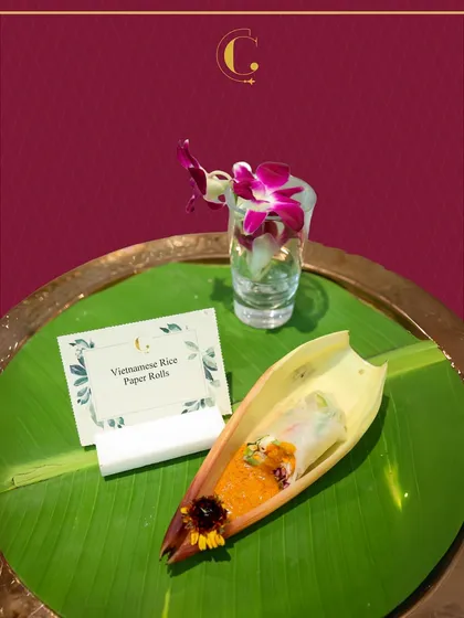 Fresh and light Vietnamese Rice Paper Rolls, presented elegantly in a banana boat on a traditional brass plate. This healthy and refreshing appetizer is perfect for any corporate event.