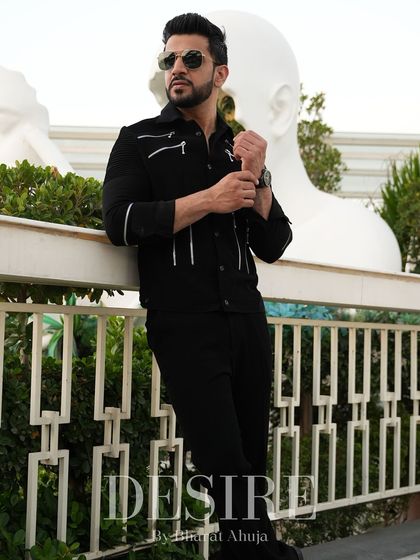 This black jacket with clean white piping offers a sharp, modern aesthetic. It's a versatile piece designed for the man who appreciates understated elegance.