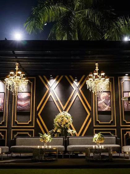 A sophisticated lounge area for a cocktail soirée. I used a black and gold color scheme with geometric patterns, plush seating, and statement chandeliers to create a luxurious, art-deco-inspired vibe.