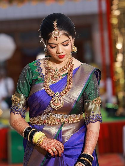 The complete bridal look, showcasing the rich saree, heavy temple jewellery, and flawless makeup.