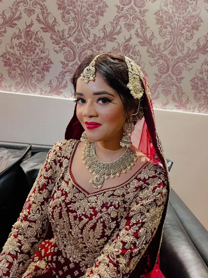 A regal portrait of the Nikaah bride, her makeup featuring classic winged eyeliner and bold red lips.