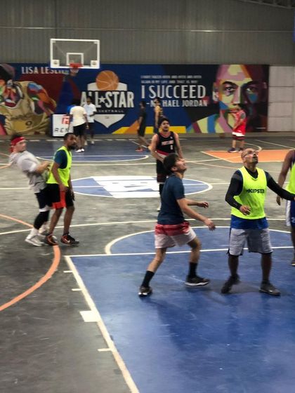Players hustle for the ball in front of our inspiring mural. The atmosphere here is all about passion for the game of basketball.
