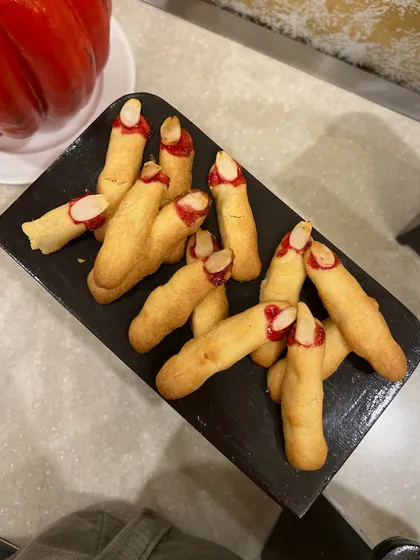 Witch finger cookies, a fun and spooky treat we made for a Halloween party. These are shortbread cookies shaped like fingers with an almond for a fingernail.
