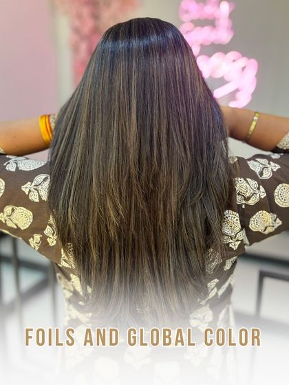 A combined look at the foils and global colour service, showcasing the final, multi-toned result against our salon's "good vibes" backdrop.