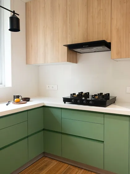 This kitchen uses green in a fresh, contemporary way. The vibrant cabinetry is a bold statement, but it’s balanced by the natural wood tones and crisp white countertops, creating a space that feels energetic and welcoming.
