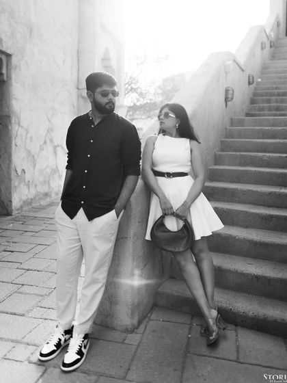 A classic black and white portrait of the couple, highlighting their fashion and chemistry.