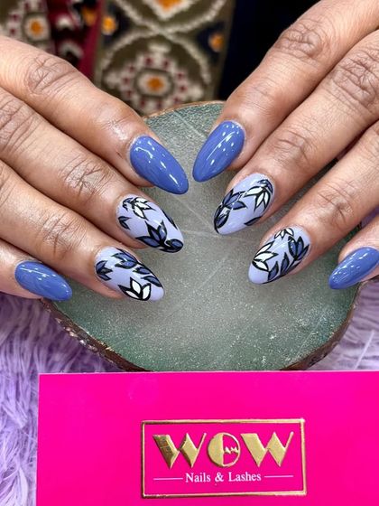 A beautiful floral design on a deep blue base. The hand-painted leaves in shades of blue and white create a sophisticated and artistic look.