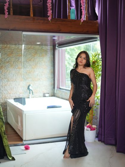 This black sequined dress with a side slit is the definition of party-ready. Perfect for a night out or a special celebration.