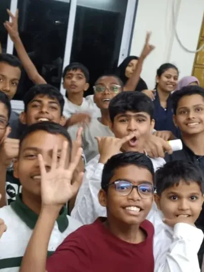 A teacher takes a happy selfie with his students on Teacher's Day, capturing the fun and informal celebration.