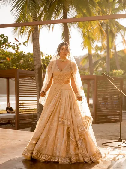 The bride, Aditi, wanted an ivory look to honor her groom's Christian roots. We found this lightweight and flowy Tarun Tahiliani lehenga, and it was love at first sight for her beach wedding.