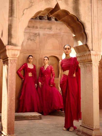 Three models styled in a powerful monochrome red for a brand campaign. I created distinct silhouettes, from a draped saree to a layered jacket set, to showcase the collection's versatility.