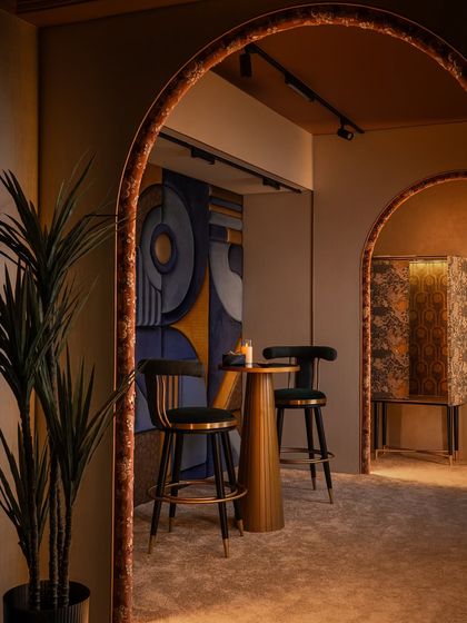 This corner of Zone Four has a subtle Art Deco influence. We custom-designed the bar chairs and wrapped a cabinet in a rich, textured fabric to create a moody and sophisticated nook, perfect for quieter moments within the bustling studio.