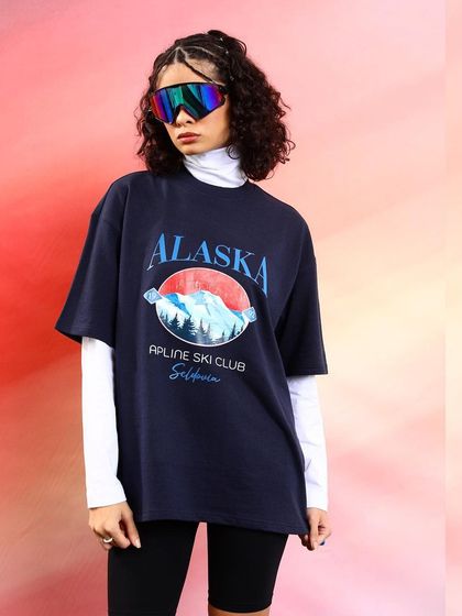 Layering is key in streetwear. Here, I styled an oversized graphic tee over a white turtleneck and paired it with cycling shorts and futuristic ski goggles for a retro-meets-modern look.