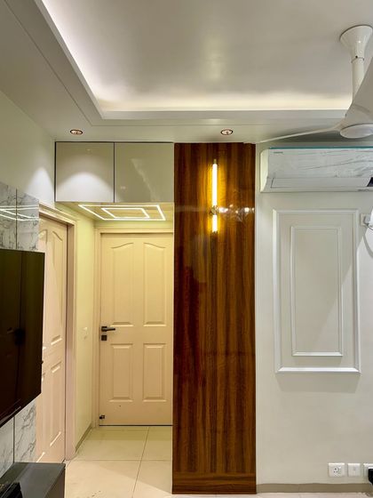 A clever way to add storage is by using the loft space above doors, concealed with a panel that matches the room's decor.