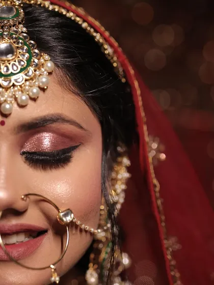A half-face portrait focusing on the stunning rose-gold shimmer eye makeup and the perfectly winged liner.