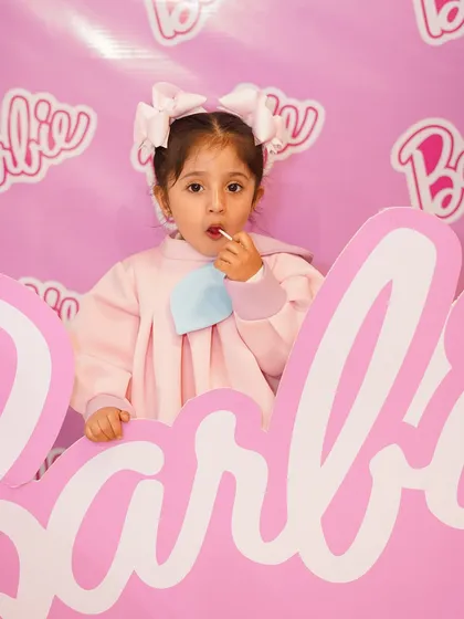 Another cute shot of the birthday girl enjoying a lollipop in the Barbie photo booth. We focus on creating a fun and carefree environment for the kids.