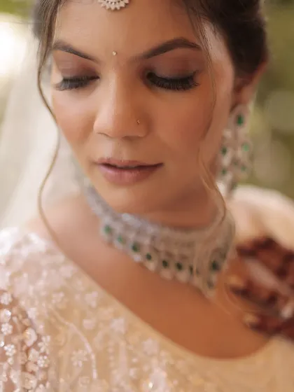 A close-up of the soft glam makeup for this bride's white wedding. The smokey eyes and nude lips create a timeless and sophisticated look.