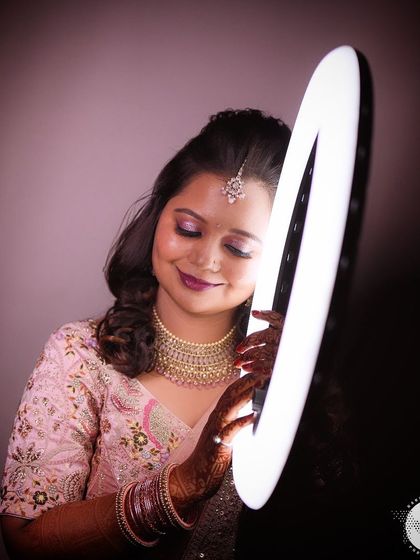 A creative shot of Kajol with a ring light, highlighting her flawless reception makeup.