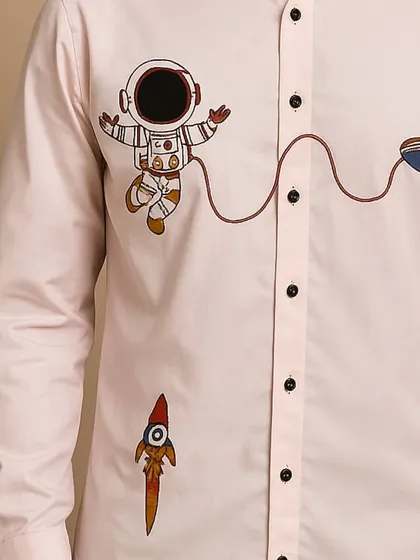 A detailed close-up of the astronaut, UFO, and rocket embroidery. Each element is carefully stitched with vibrant colors, showcasing the fun side of bespoke menswear.