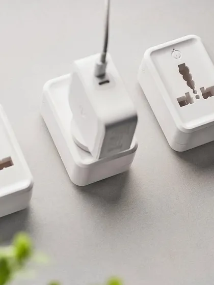 This shot for Phynart shows their smart plugs in a lifestyle context. The flat lay with a laptop and plant makes the technology feel like a natural part of a modern, organized workspace.