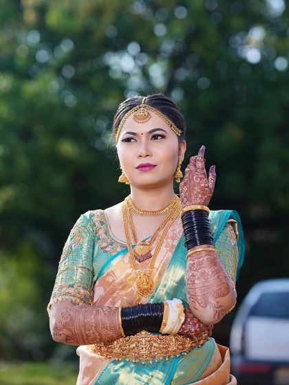 A beautiful outdoor shot of Arpitha, her makeup looking flawless against the natural background.