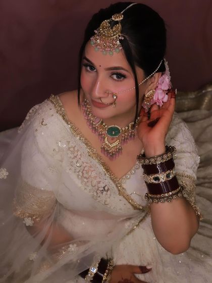 A close-up of the bride in our rental couture, showing how the outfit, jewelry, and makeup come together for a stunning look.