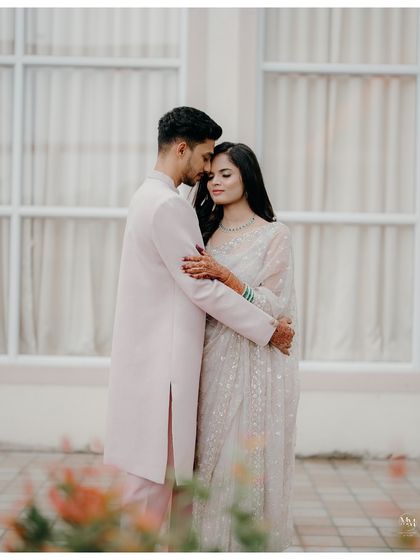 A quiet, tender embrace. Dressed in elegant attire, this portrait focuses on their emotional connection and the peaceful comfort they find in each other.