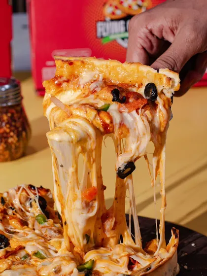 Sometimes, a single image is all you need to make someone hungry. This classic, gooey cheese pull on a slice of pizza is a perfect example of how we capture that one mouth-watering moment that converts viewers into customers.