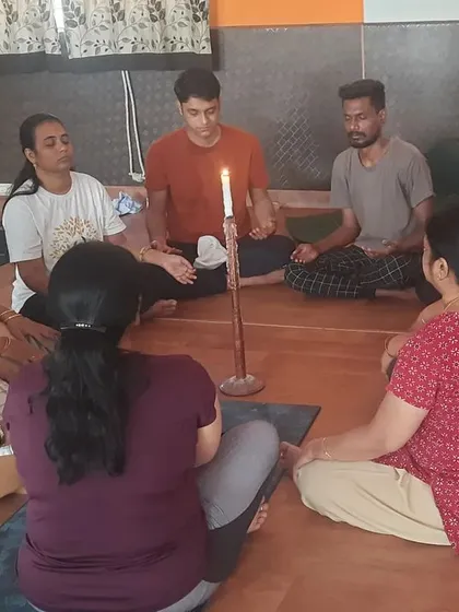 Here, a group practices Jyoti Trataka Kriya, or candle gazing, a powerful yogic technique for improving focus and calming the mind. This is one of the many mindfulness practices I use to combat workplace stress and enhance mental clarity.