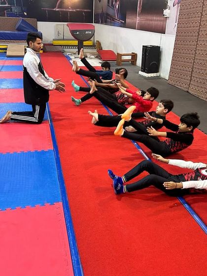 Core strength is everything in gymnastics. I lead my students through a series of V-ups and other abdominal exercises to build the strong midsection required for every skill they will learn.