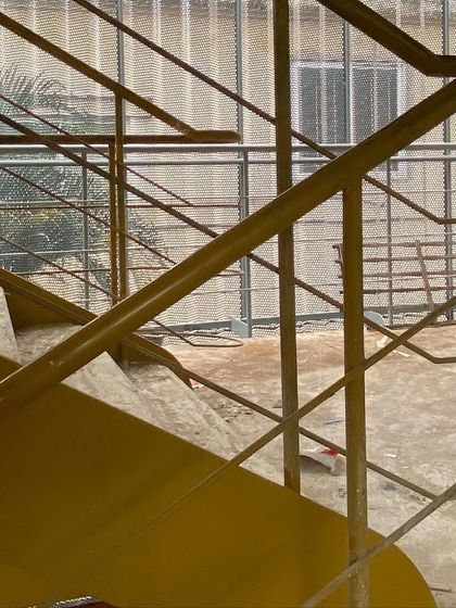 The fluid lines of a new steel staircase during construction. We pay close attention to the details of circulation, designing staircases and railings that are not just functional but also add a sculptural quality to the space.