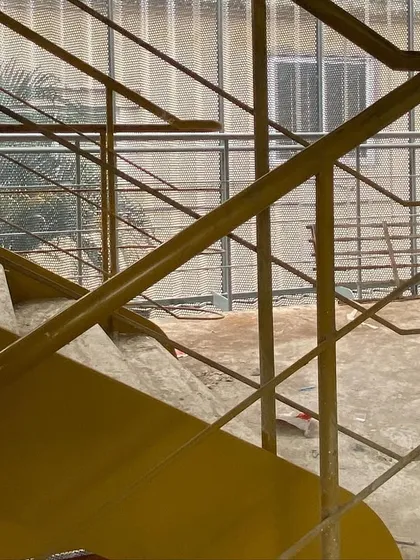 The fluid lines of a new steel staircase during construction. We pay close attention to the details of circulation, designing staircases and railings that are not just functional but also add a sculptural quality to the space.