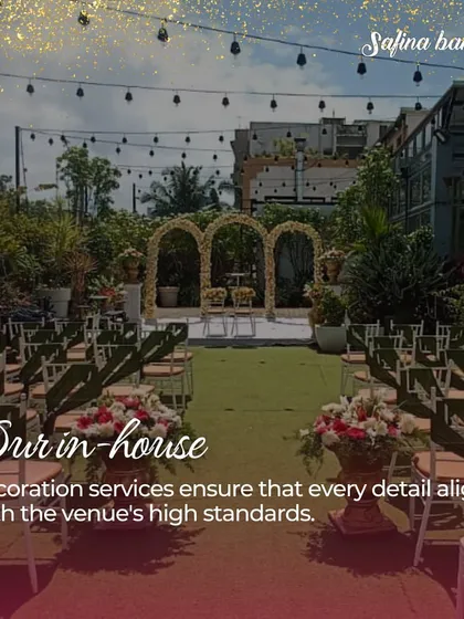 A daytime view of the Sky Terrace set for a ceremony, showcasing the lush green aisle and floral archways, all handled by our in-house decoration services.