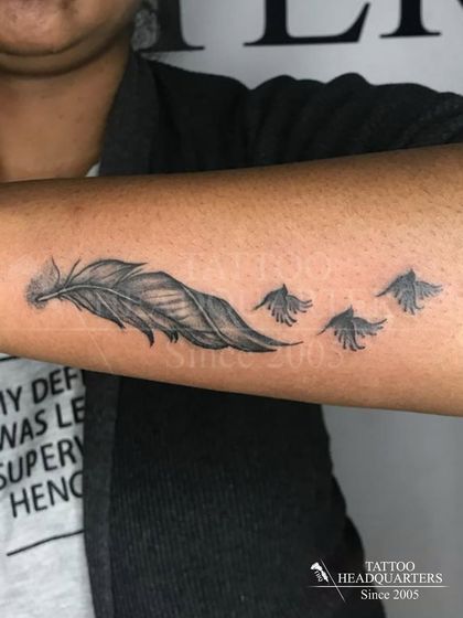 A feather dissolving into a flock of birds, a beautiful and popular tattoo symbolizing freedom and transformation.