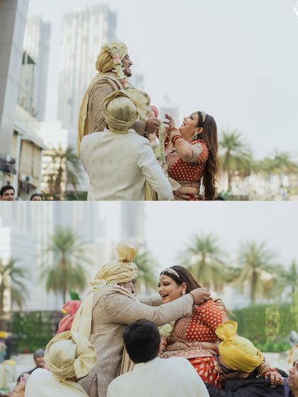 The playful and joyous struggle during the varmala ceremony, as friends lift the couple up. These shots are full of laughter and capture the fun side of wedding rituals.