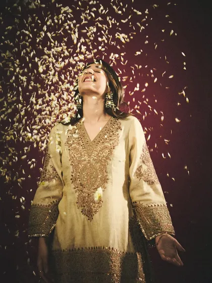 A moment of pure joy. Dhvani Bhanushali in a Heena Kochhar kurta, showered with flower petals during a photoshoot. It's these unscripted moments that often make the best shots.