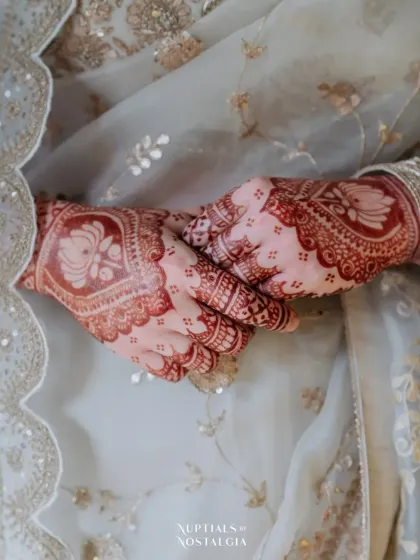 The final stain is just as important as the initial design. I use my own natural henna paste to achieve this beautiful, deep reddish-brown color that looks stunning against the bride's wedding attire.