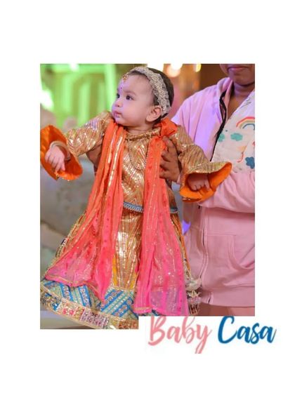 Another one of our little clients looking gorgeous in a multi-colored ethnic gown for her first Lohri party. The outfit is designed to be both grand and comfortable.