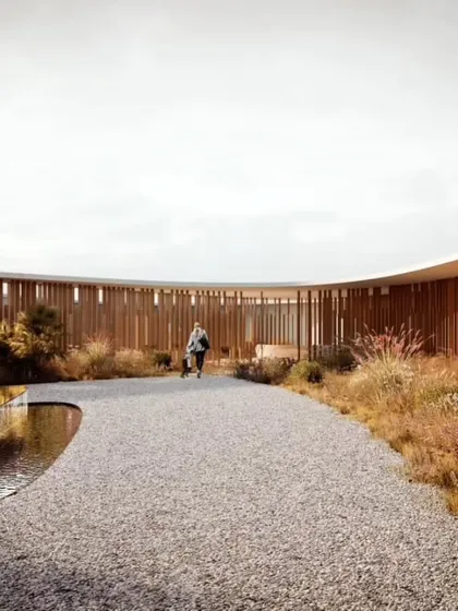 The internal courtyard of Amar Villa, featuring a tranquil water body and a walkway shielded by vertical wooden fins. This space offers a serene transition zone that balances privacy and openness.