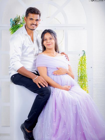 A happy couple's portrait. The lavender Breezy gown is a sweet and romantic choice for celebrating your journey to parenthood.