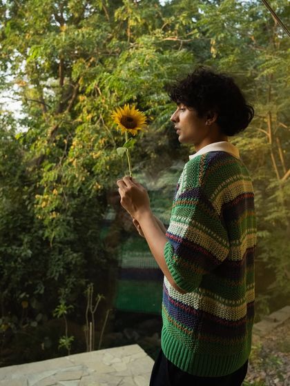 A guest finds a moment of quiet connection with a single sunflower, embodying the simple, heartfelt beauty we cultivate here.