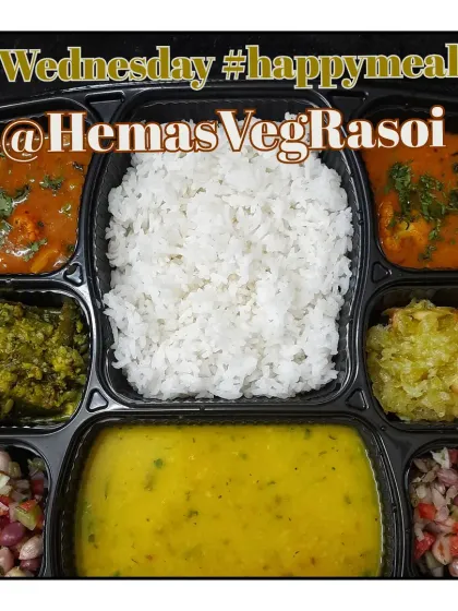 A wholesome meal of mix dal, rice, gilka (ridge gourd) sabzi, gobi mutter, and a sweet dudhi halwa, accompanied by a fresh peanut salad.