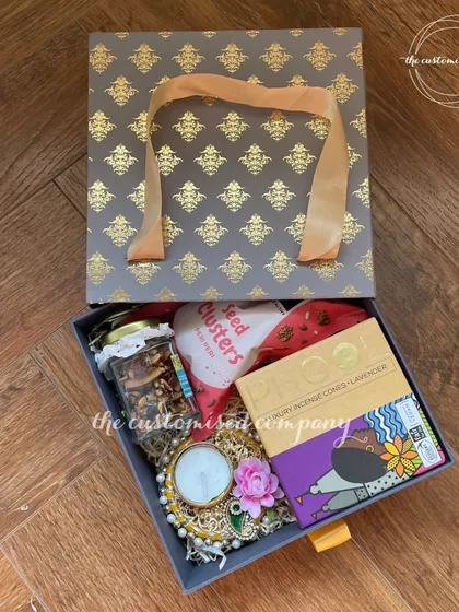 This is my all-in-one corporate Diwali solution. A sophisticated box bag holds everything needed for the festival: luxury incense, a decorative diya, healthy seed clusters, and a personalized note.