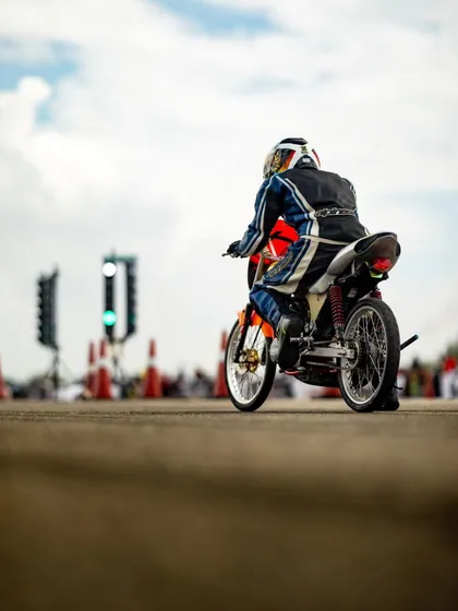 A rider on a custom drag bike at the starting line, waiting for the green light.